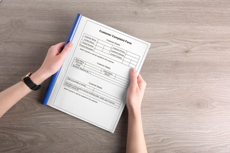 woman holding complaint form wooden table top view 1339860 3939